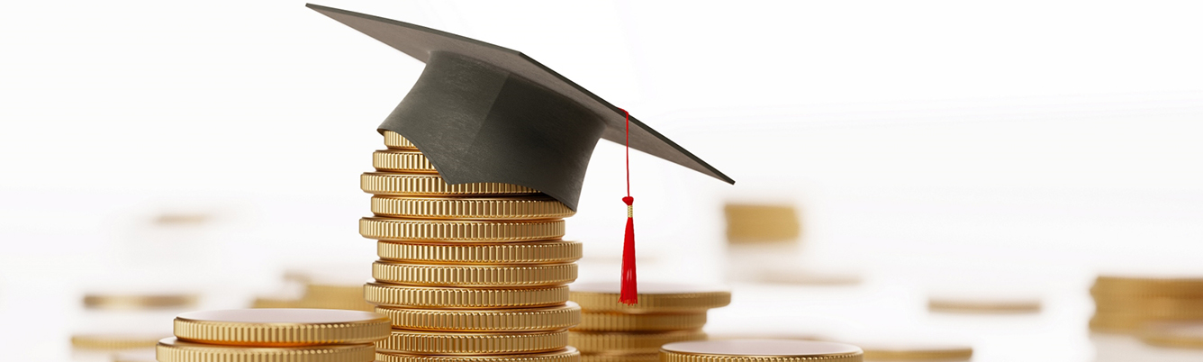 stack of gold coins with a graduation cap on top