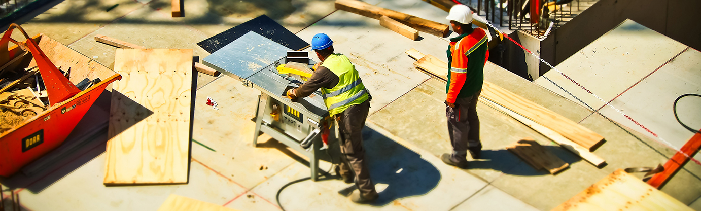 two construction workers working on construction site